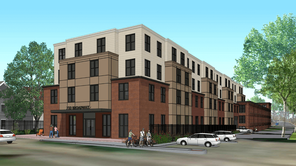 Modern 4 story brick building on a corner lot, beautiful trees.