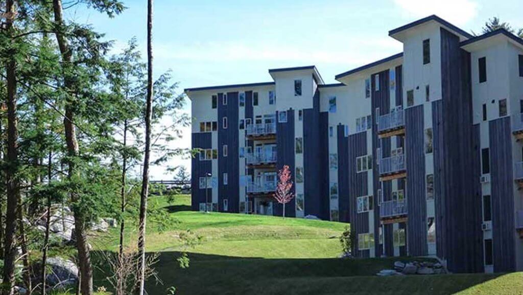 Modern buildings in a wooded setting.