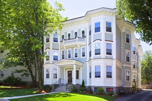 Victorian style apartment building with large beautiful trees