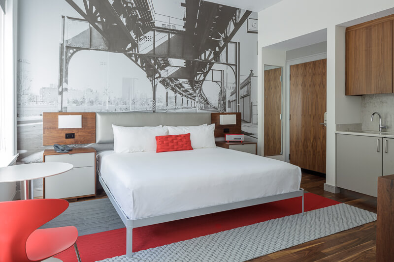 modern bedroom with retro black and white photo mural, hard plank flooring