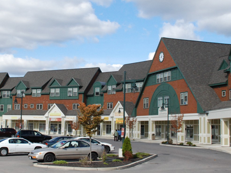 Businesses on street level with a parking lot, quarter circle layout,