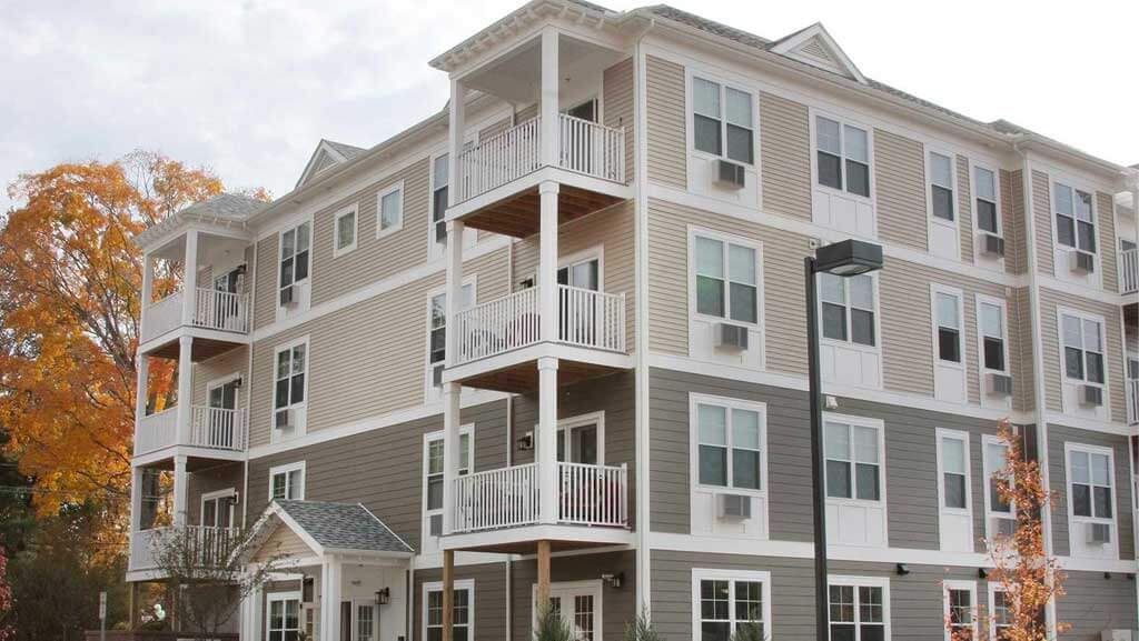 Four story building with balconies.